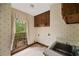 Laundry room features wallpaper and a window to the backyard at 1595 Bakers Glen Dr, Atlanta, GA 30350