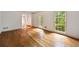 Bright living room with hardwood flooring and large windows providing natural light at 1595 Bakers Glen Dr, Atlanta, GA 30350
