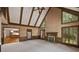Open-concept living room with vaulted ceilings, fireplace, and windows offering natural light at 1595 Bakers Glen Dr, Atlanta, GA 30350