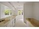 Bright main bathroom with double vanity, bathtub, and views of lush greenery at 1595 Bakers Glen Dr, Atlanta, GA 30350