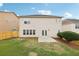 Backyard featuring green grass, a wood fence, and a two-story house at 230 Collins View Ct, Lawrenceville, GA 30043