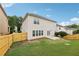 Fenced backyard featuring a concrete patio and lush lawn at 230 Collins View Ct, Lawrenceville, GA 30043