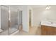 Bright bathroom featuring tile floor, cherry cabinets, and a glass shower enclosure at 230 Collins View Ct, Lawrenceville, GA 30043