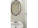 Elegant bathroom with an oval mirror and a modern sink at 230 Collins View Ct, Lawrenceville, GA 30043