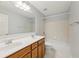 Bathroom featuring a double vanity, shower and tub combination, and neutral tile at 230 Collins View Ct, Lawrenceville, GA 30043