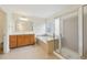 Bathroom with double sinks, glass shower, and an inviting soaking tub at 230 Collins View Ct, Lawrenceville, GA 30043