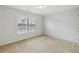 Bedroom bathed in natural light with neutral walls and plush beige carpeting at 230 Collins View Ct, Lawrenceville, GA 30043