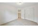 Neutral bedroom with plush carpet and a spacious closet near staircase landing at 230 Collins View Ct, Lawrenceville, GA 30043