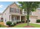 Charming two-story home with brick and siding, a covered porch, and a well-maintained lawn at 230 Collins View Ct, Lawrenceville, GA 30043