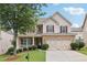 Charming two-story home with brick and siding, attached two-car garage, and manicured landscaping at 230 Collins View Ct, Lawrenceville, GA 30043
