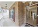 Charming front porch with brick siding, traditional railing, and an inviting view of the interior at 230 Collins View Ct, Lawrenceville, GA 30043