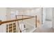 Upstairs hallway and staircase showing white trim, wooden railing, and carpet on the stairs and hallway at 230 Collins View Ct, Lawrenceville, GA 30043