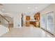 A spacious kitchen includes an island, tile floors, stainless steel refrigerator, and access to the backyard at 230 Collins View Ct, Lawrenceville, GA 30043