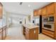 Open kitchen boasts an island, stainless steel appliances, and a view into the living room with fireplace at 230 Collins View Ct, Lawrenceville, GA 30043