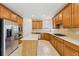 Well-equipped kitchen with stainless steel appliances, wooden cabinets, and a center island at 230 Collins View Ct, Lawrenceville, GA 30043