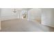 Elegant living room with carpet flooring, wainscoting, and an archway leading to an adjacent room at 230 Collins View Ct, Lawrenceville, GA 30043