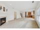 Open living space with a fireplace flows into the kitchen, perfect for entertaining and modern living at 230 Collins View Ct, Lawrenceville, GA 30043