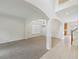 Open living room features a chandelier, wainscoting, arched doorways, and views of the staircase at 230 Collins View Ct, Lawrenceville, GA 30043