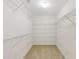 Spacious walk-in closet with ample shelving and neutral carpet at 230 Collins View Ct, Lawrenceville, GA 30043