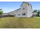 View of the home's backyard featuring a large lawn, privacy fence, and view of neighboring houses at 2537 Sori Dr, Buford, GA 30519