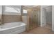 This bathroom features a tub and shower at 2537 Sori Dr, Buford, GA 30519