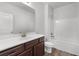 A bathroom with white walls, dark wood cabinets, a single sink, and a white toilet at 2537 Sori Dr, Buford, GA 30519