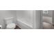 Bathroom featuring a toilet, tub, and view of a hallway and bedroom at 2537 Sori Dr, Buford, GA 30519