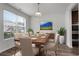 Bright dining room features a modern light fixture, lovely table set and large window at 2537 Sori Dr, Buford, GA 30519