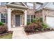 Close up of a charming home entrance with blooming bushes and fresh green plants at 2537 Sori Dr, Buford, GA 30519