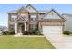 Traditional brick home with a well-manicured lawn and a two-car attached garage at 2537 Sori Dr, Buford, GA 30519