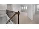 Spacious hallway with carpet and iron railing overlooks the stairs and opens to a living area with natural light at 2537 Sori Dr, Buford, GA 30519