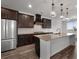 A modern kitchen with stainless steel appliances, a granite countertop, and custom cabinetry at 2537 Sori Dr, Buford, GA 30519