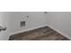 This laundry room features wood-look floors and convenient hookups for laundry machines at 2537 Sori Dr, Buford, GA 30519