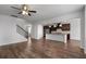 Open living area with hardwood floors, a large island, and staircase with metal railings at 2537 Sori Dr, Buford, GA 30519