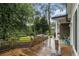 Inviting backyard deck with a jacuzzi, lush greenery, and a stone accent wall at 525 Arbor Creek Ct, Roswell, GA 30076