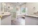 Bright bathroom featuring double sinks, soaking tub and glass shower with marble tile surround at 525 Arbor Creek Ct, Roswell, GA 30076