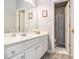 Clean bathroom featuring a white vanity and framed mirror at 525 Arbor Creek Ct, Roswell, GA 30076