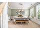 Formal dining room with elegant chandelier and light green walls at 525 Arbor Creek Ct, Roswell, GA 30076