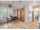 Dining room with vaulted ceilings, a large window, and a custom shelving unit with a hidden door at 525 Arbor Creek Ct, Roswell, GA 30076