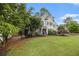 Charming gray two-story home with manicured lawn and beautiful landscaping at 525 Arbor Creek Ct, Roswell, GA 30076