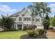 Charming gray two-story home with manicured lawn and beautiful landscaping at 525 Arbor Creek Ct, Roswell, GA 30076