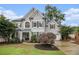 Charming gray two-story home with manicured lawn and beautiful landscaping at 525 Arbor Creek Ct, Roswell, GA 30076