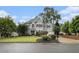 Charming gray two-story home with manicured lawn and beautiful landscaping at 525 Arbor Creek Ct, Roswell, GA 30076