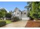 Charming gray two-story home with manicured lawn and beautiful landscaping at 525 Arbor Creek Ct, Roswell, GA 30076