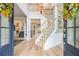 Inviting foyer with hardwood floors, staircase, and views into the living spaces at 525 Arbor Creek Ct, Roswell, GA 30076