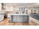 Bright eat-in kitchen features a large central island with sink and ample counter space at 525 Arbor Creek Ct, Roswell, GA 30076