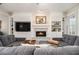 Inviting living room features a fireplace, built-in shelving, and a large comfortable sectional sofa at 525 Arbor Creek Ct, Roswell, GA 30076
