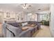 Open-concept living room, showcasing a large sectional sofa, eat-in kitchen, and entry to the house at 525 Arbor Creek Ct, Roswell, GA 30076