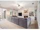 Spacious living room featuring a large sectional, built-in shelves, fireplace, and lots of light at 525 Arbor Creek Ct, Roswell, GA 30076