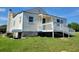Exterior view of the home with a back porch and a carport on the side at 7217 Union Grove Rd, Lithonia, GA 30058